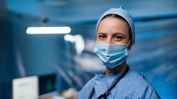 Doctor in hospital looking at camera, coronavirus concept. medical, corona, virus, coronavirus, epidemic, disease, illness, health, flu, pneumonia, infection, pandemic, fever, outbreak, quarantine, prevention, contagious, respiratory, contamination, risk, syndrome, protection, concept, mask, sickness, sars, respirator, infected, hospital, room, indoors, inside, clinic, covid, covid 19, alert, care, sick, cure, dangerous, woman, females, doctor, test, copy, space, looking, camera