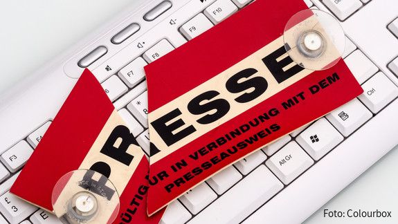 Pressefreiheit Auf einer Computertastatur liegt ein in Zwei geteiltes Schild mit der Aufschrift Presse